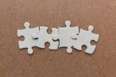 jigsaw puzzle on brown woodenの写真素材