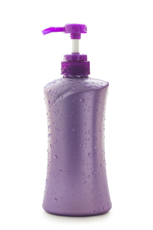 purple plastic bottles for bathroom on white backgroundの写真素材