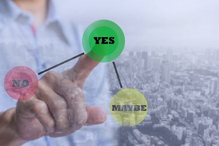 Hand of businessman press Yes button with town background. Concept of decision making.の写真素材