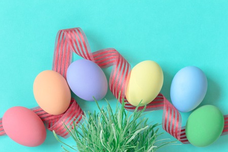 pastel easter eggs on green background in top viewの写真素材