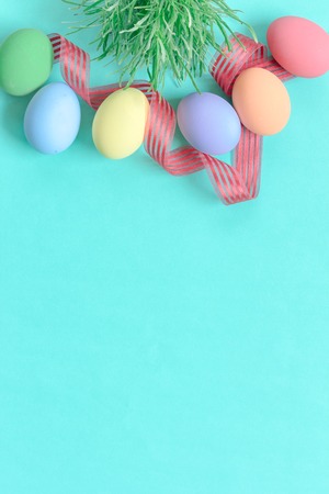 pastel easter eggs on green background in top viewの写真素材