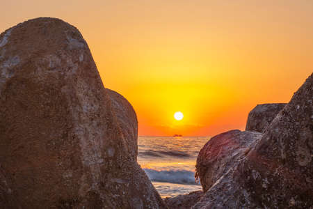 Morning sun rising between tetrapods