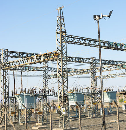 High-voltage substation with switches and insulators. Industrial background