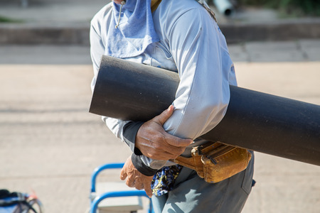Man holding Plumbing for connection of plastic pipes