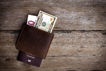 Passport with a note on a wooden table.
