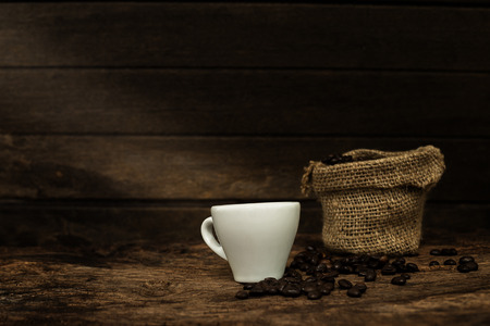 espresso coffee cup and coffee beans on old wooden background - dark toneの写真素材