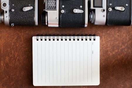 blank notebook with vintage camera.