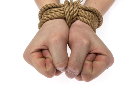 hands tied with a rope on white backgroundの写真素材