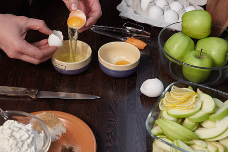 The man prepares in kitchen of apple pie with citrus