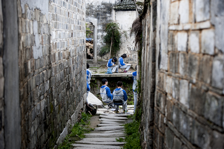 Student painting at the ancient architecture village back alleyのeditorial素材