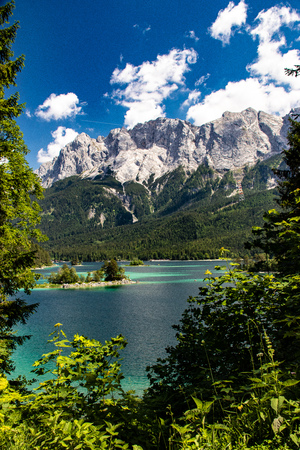 Azure water at Eibsee lake at the foot of Mt. Zugspitze. Location famous resort Garmisch-Partenkirchen, Bavarian alp, Europe. Scenic image of popular travel destination. Discover the world's beauty.の写真素材