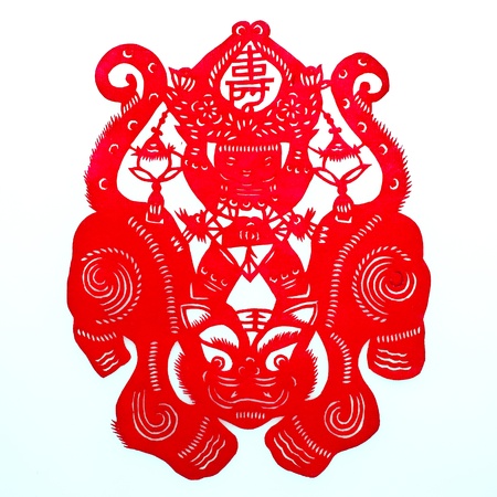 Boy Riding Tiger.A traditional Chinese paper cutting depicting a chubby boy in traditional bellyband riding a huge tiger, holding a longevity peach.の写真素材