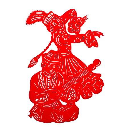 Xinjiang Lad and Girl .A traditional Chinese paper cutting of a lad playing the musical instrument Dombra, with a girl in long braid dancing by the side. Both of them wear traditional ethnic Uygur clothing.の写真素材