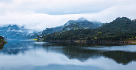 The lake reflects mountains and clouds