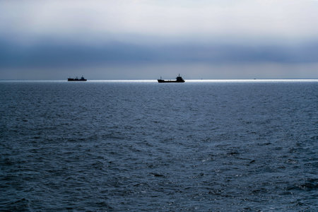 Silhouette of a ship sailing on the sea.