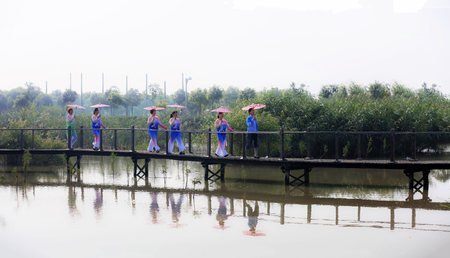 Chinese women walking on bridge in traditional costumeのeditorial素材