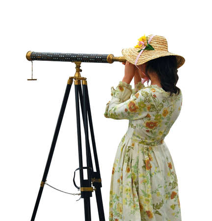 Girl in fancy dress and hat looking through telescope - isolated.