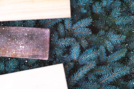 An old board on the background of branches of a Christmas tree. Close-up. There is a place for an...