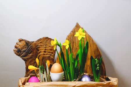 Easter eggs and flowers in a craft paper bag. Back background from old boards. The basis for your design, postcard, congratulations.の写真素材