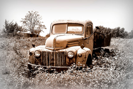 Old farm pick-up truck rusting in a pastureの写真素材