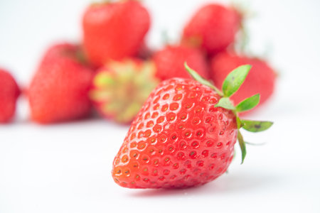 several strawberries are removed from the glare on a white backgroundの写真素材