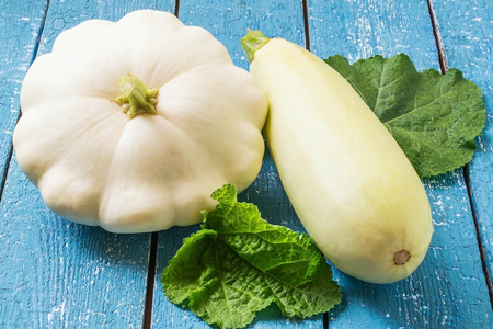 Organic vegetables: zucchini and pattypan squash on a blue wooden backgroundの写真素材