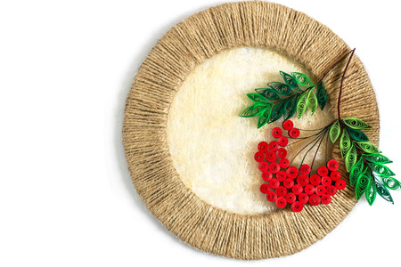 Autumn decoration: Rowan in quilling techniques in jute circle on a white backgroundの写真素材