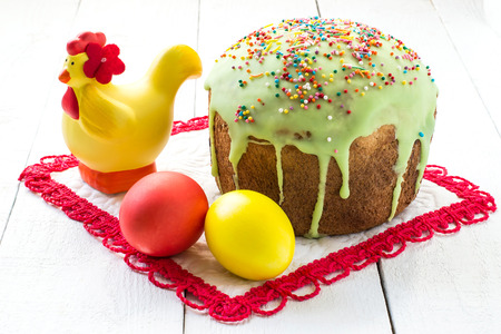 Traditional Easter treats: Easter cakes and colorful easter eggs on a white tableの写真素材