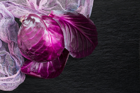 Scotch kale or red cabbage on a slate board. It is used in dietary and vegetarian food, as well as for the prevention of cardiovascular diseasesの写真素材