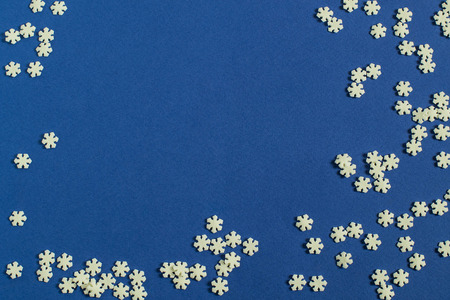 Graceful Christmas background with sugar decoration in form of snowflakes. Scattering of snowflakes...