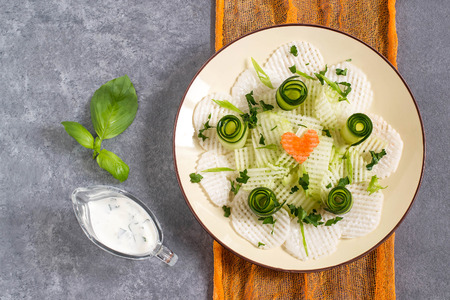 Vitamin salad from daikon with cucumber and herbs. Served with yoghurt sauce. Detox. Vegetarian, healthy and diet food. Top viewの写真素材