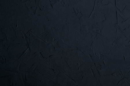 Abstract textured background of dark gray putty. Imitation of surface of stone. Rough texture as...