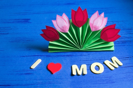 Child makes gift to March 8 or Mother's Day. Colorful bouquet of tulips from paper. Children's art project. DIY concept. Step-by-step photo instruction. Step 9. Final resultの写真素材