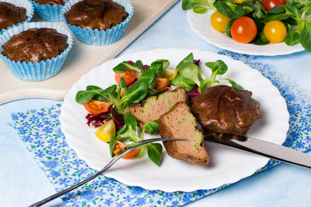 Chicken liver souffle with broccoli. Served with fresh salad from lamb salad, radicchio and cherry tomatoes. Baked in muffin molds in ovenの写真素材