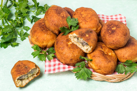 Delicious fried patties with eggplant and cheese. Homemade patties with vegetables. On green table...