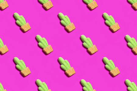 Pink background with gummy candies in form of cactus. Bright colorful pattern. Fun trendy style. Minimalism, pop artの写真素材