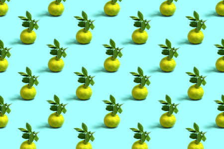 Bright pattern of tangerines with leaves on light blue backgroundの写真素材