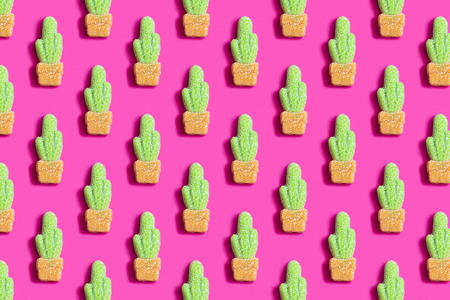 Pink background with gummy candies in form of cactus. Bright colorful pattern. Fun trendy style. Minimalism, pop artの写真素材
