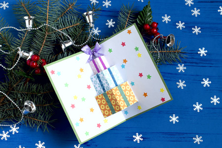 Child makes card with 3D gifts for Christmas
