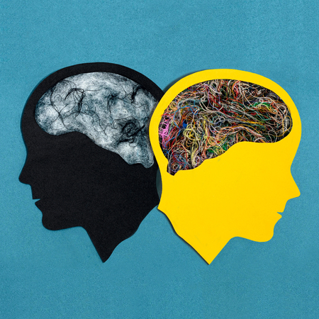 Two stylized head silhouettes. Symbolic image of two different mental states of one person. Bipolar...