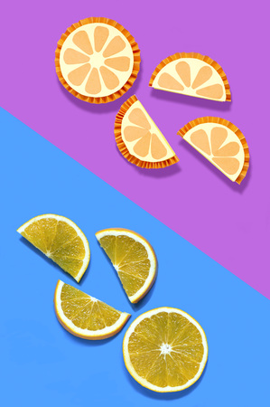 Slices of oranges and their paper models on two-color background. Paper handicraft and paper art