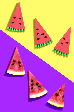 Watermelon pieces and their paper models on two-color background. Paper handicraft and paper artの写真素材