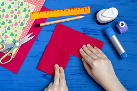 Making greeting card for Valentine's Day. DIY art concept. Step-by-step photo instruction. Step 5. Fold in halfの写真素材