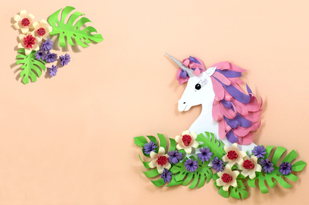 Colorful unicorn and flowers made of paper. Unicorn - symbol of magic, fulfillment of dreams. Paper art and paper craft. Invitation or holiday card for Valentine's Day, birthday and other holidaysの写真素材