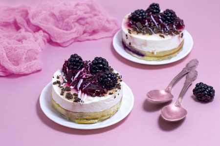 Delicious cakes with delicate souffle, blackberries and chocolate crumbの写真素材