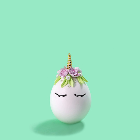 Cute handmade unicorn made of egg. Creative Easter decor, kawaii style. Minimal easter conceptの写真素材