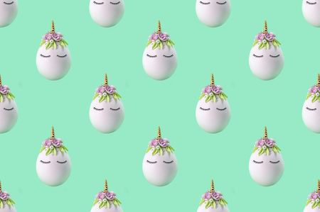 Pattern of cute unicorns made of eggs. Creative Easter background in kawaii styleの写真素材