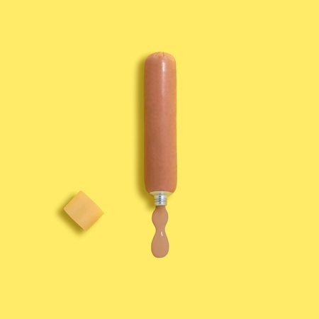 Sausage as a tube of paint. Constructed, artificial objects that mimic natural forms. Minimal style. Creative idea, imagination and fantasy. Original pop art conceptの写真素材