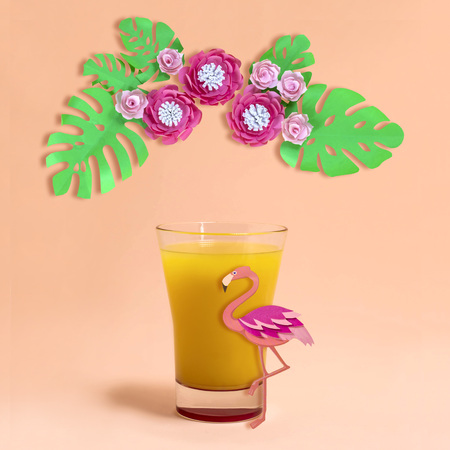 Multifruit juice in glass for tropical party. Decorating summer drinks. Paper decorations: flamingos, flowers and leaves. Paper art and paper craft. Minimal styleの写真素材