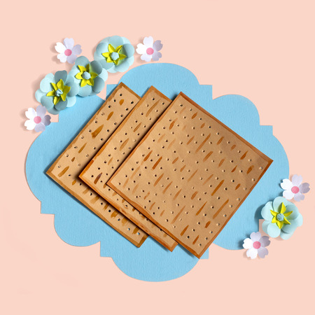 Colorful decorative frame with matzo bread and flowers for Jewish holiday Passover (Pesach). Card...